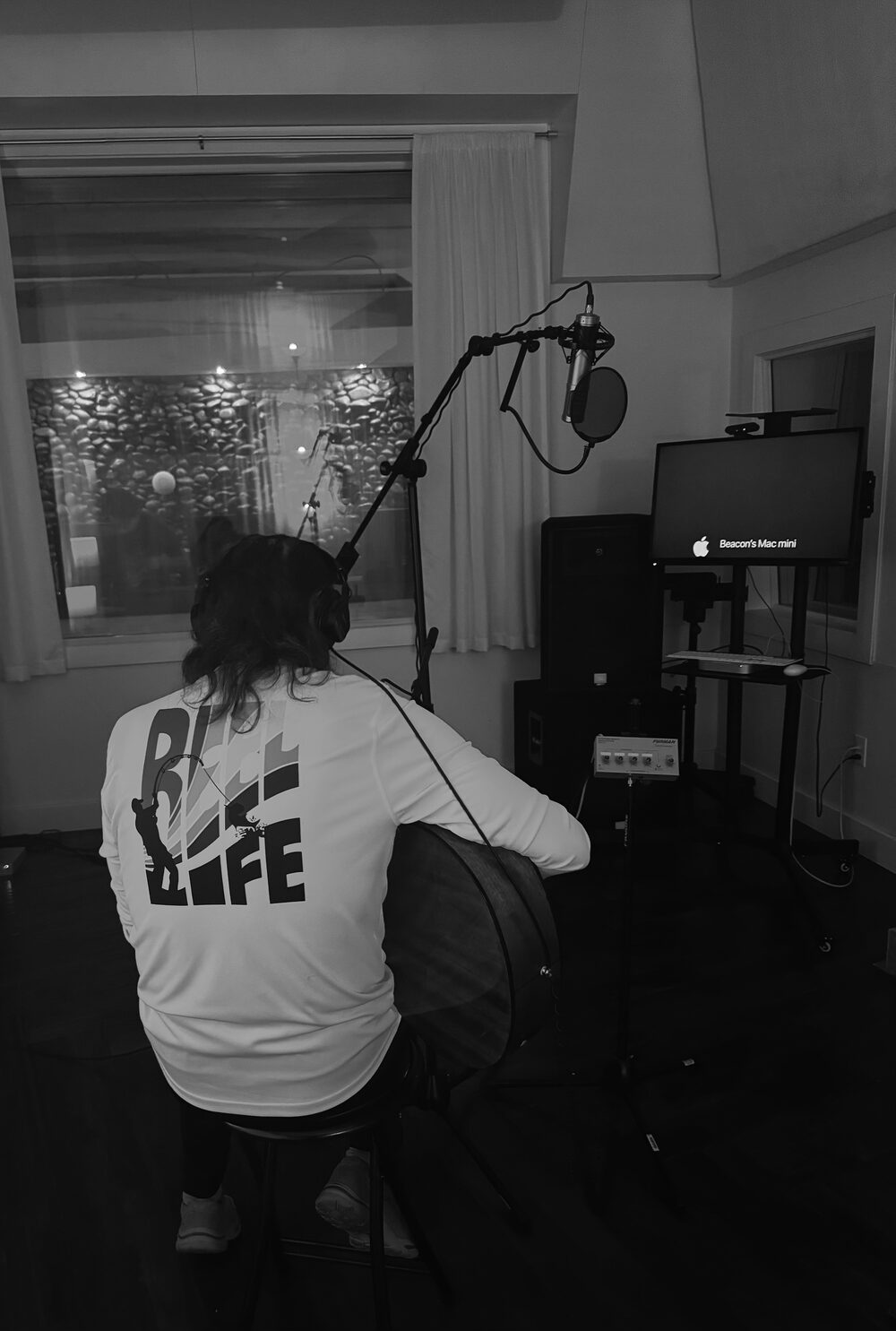 Maxx Alley recording an acoustic guitar take in the studio live room